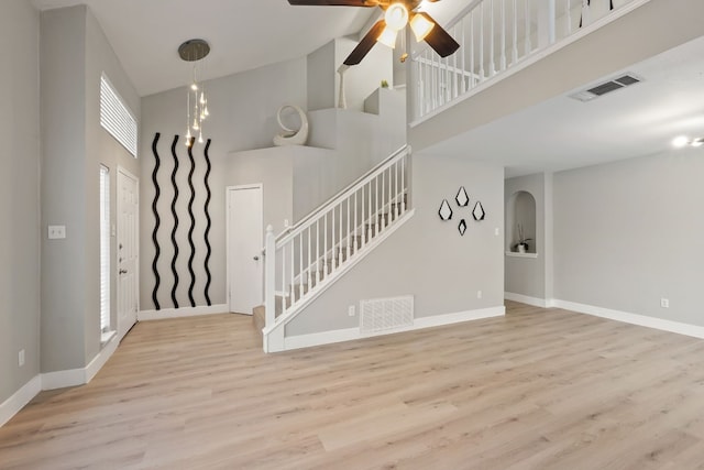 interior space featuring high vaulted ceiling, ceiling fan, and light wood-type flooring