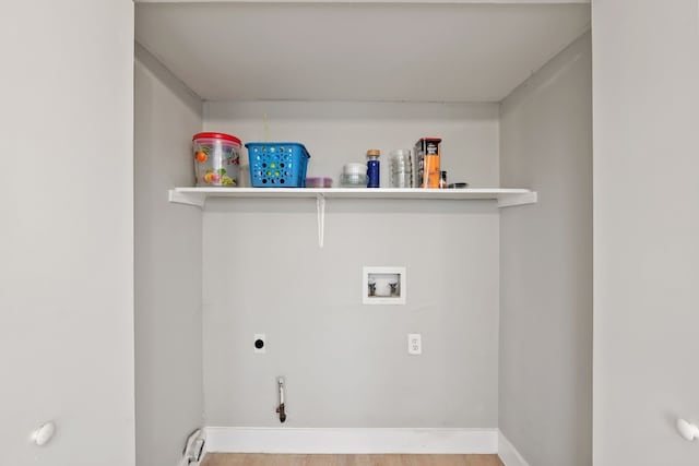 clothes washing area with wood-type flooring, hookup for an electric dryer, and washer hookup