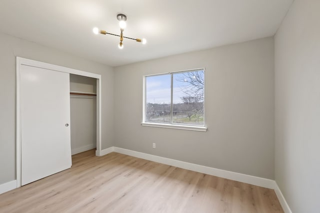 unfurnished bedroom featuring a closet and light hardwood / wood-style flooring