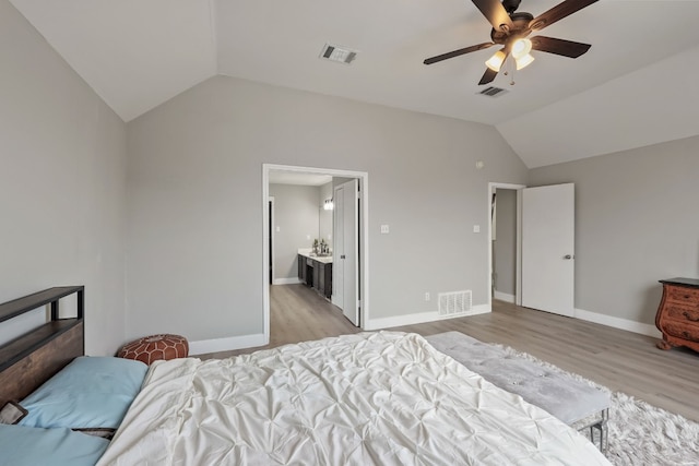 bedroom with lofted ceiling, light hardwood / wood-style floors, ceiling fan, and ensuite bathroom