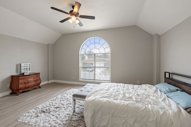 bedroom featuring lofted ceiling, ceiling fan, and light wood-type flooring