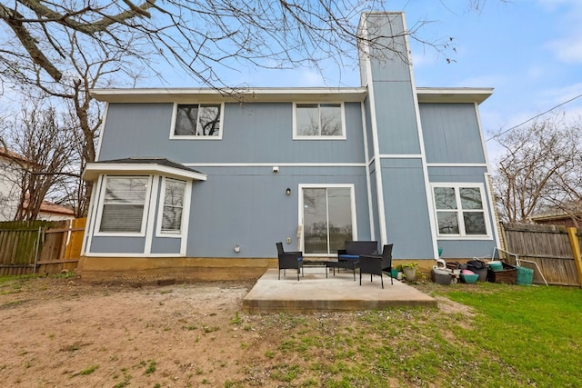 back of property featuring a patio and a yard