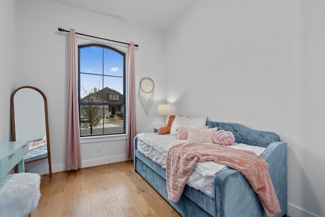 113 University Lands Dr, Liberty Hill, TX 78642 - bedroom featuring wood-type flooring and baseboards