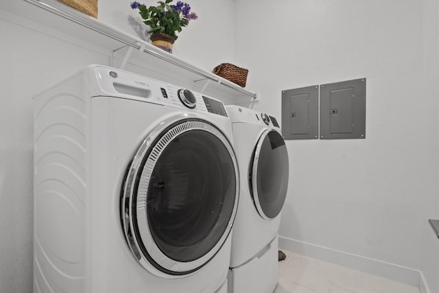 113 University Lands Dr, Liberty Hill, TX 78642 - washroom featuring electric panel, independent washer and dryer, marble look tile flooring, and baseboards