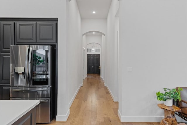113 University Lands Dr, Liberty Hill, TX 78642 - hallway featuring arched walkways, baseboards, light wood-style flooring, and recessed lighting