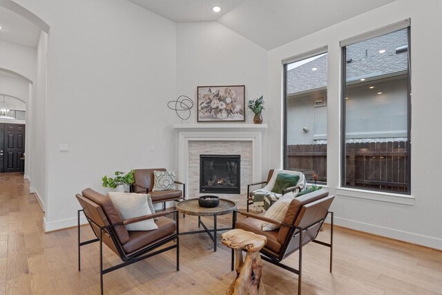 113 University Lands Dr, Liberty Hill, TX 78642 - living area with arched walkways, a fireplace, light wood-type flooring, recessed lighting, and high vaulted ceiling