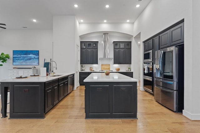 113 University Lands Dr, Liberty Hill, TX 78642 - kitchen featuring stainless steel appliances, a sink, wall chimney exhaust hood, a kitchen island, and light countertops