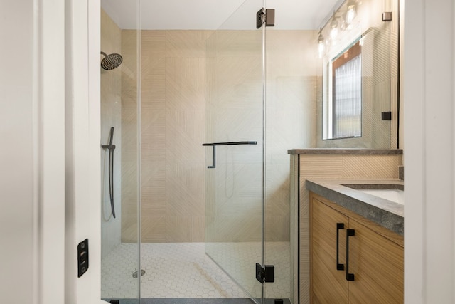 bathroom featuring vanity and a shower with shower door