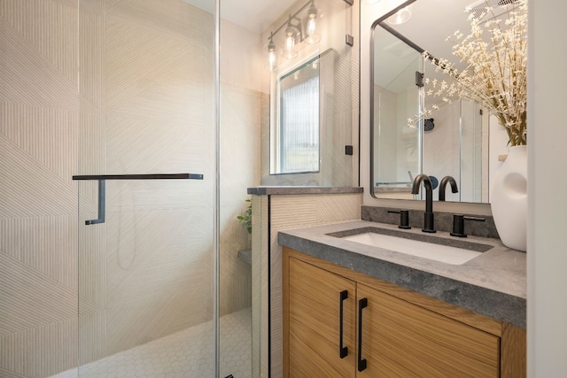 bathroom with walk in shower and vanity