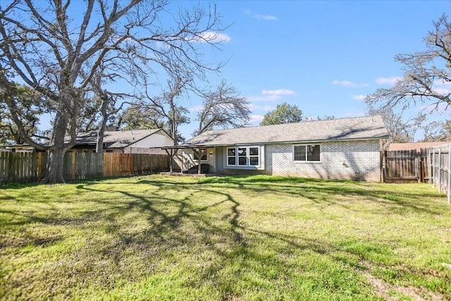 back of house featuring a lawn