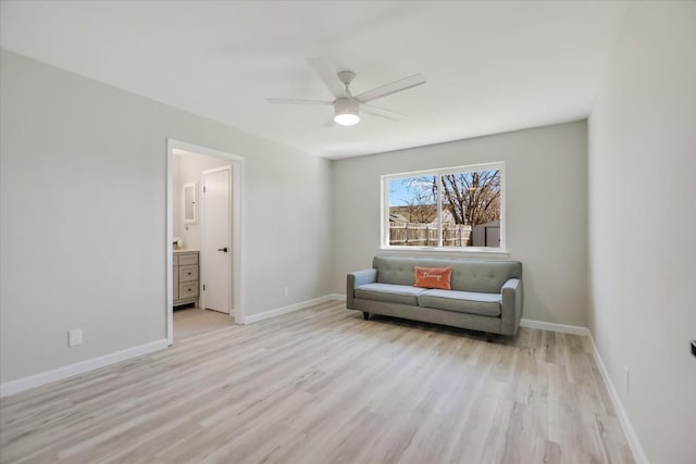 living area featuring ceiling fan and light hardwood / wood-style floors