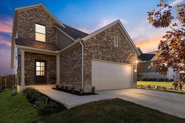 view of front of property with a garage and a lawn