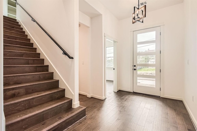 22300 Shotts Dr, Spicewood, TX 78669 - entryway with stairs, dark wood-style floors, a chandelier, and baseboards