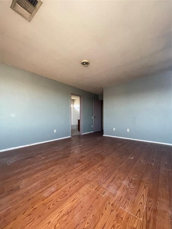 spare room featuring dark wood-type flooring