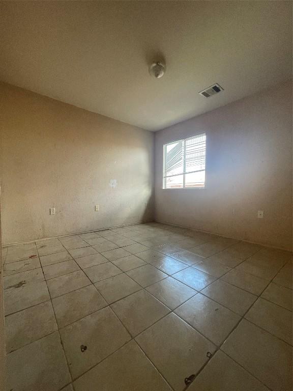 unfurnished room with light tile patterned floors