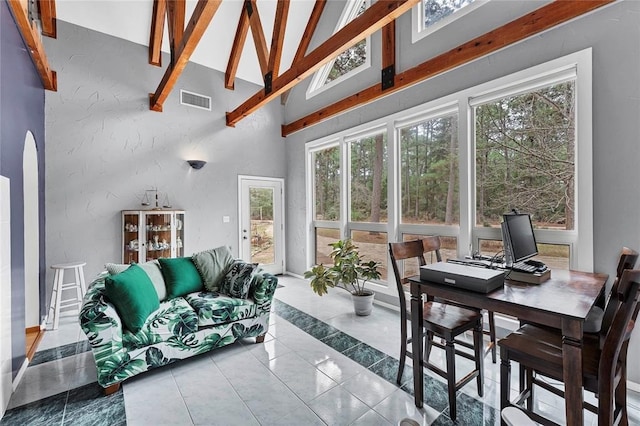 sunroom / solarium with vaulted ceiling with beams