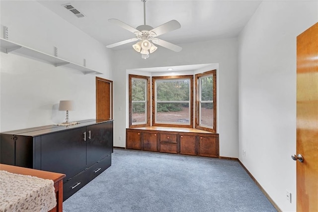 kitchen with ceiling fan and carpet flooring