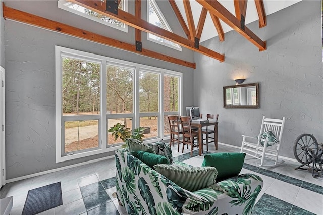 tiled living room featuring high vaulted ceiling