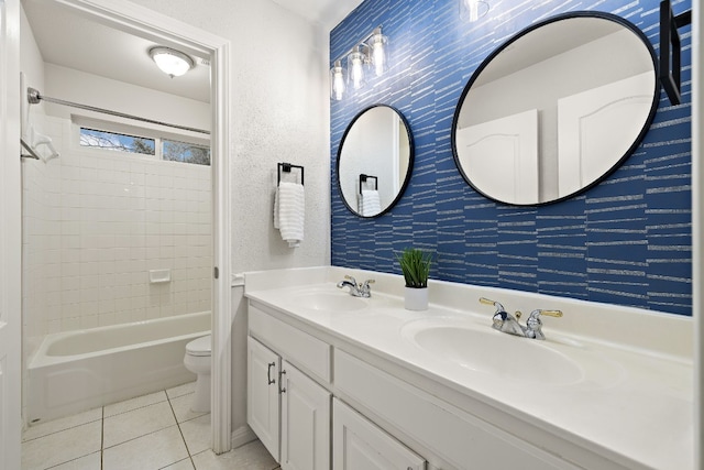 full bathroom with tiled shower / bath, vanity, tile patterned floors, and toilet