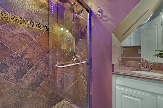 bathroom featuring vanity and a shower with shower door