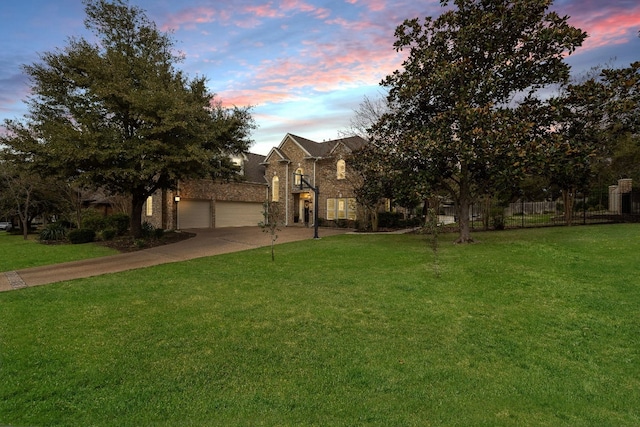 view of front facade featuring a garage and a yard