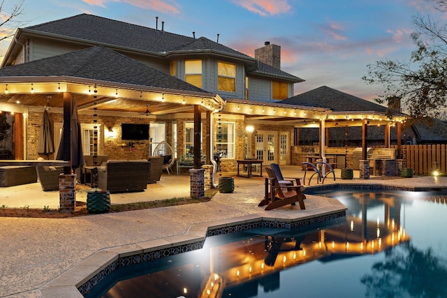 view of swimming pool featuring a patio, an outdoor kitchen, an outdoor hangout area, an outdoor bar, and a gazebo