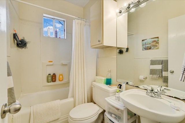 full bathroom featuring sink, shower / bath combo with shower curtain, and toilet