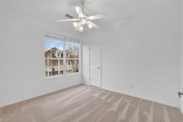 empty room with light colored carpet and ceiling fan