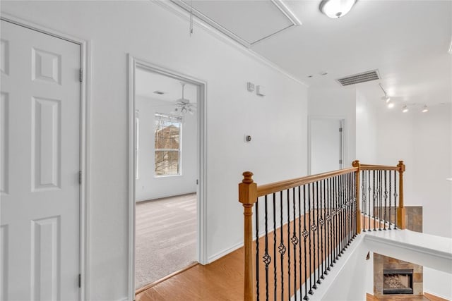 hall featuring ornamental molding and light hardwood / wood-style floors