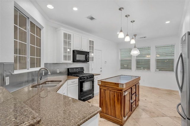 kitchen with white cabinetry, sink, hanging light fixtures, a center island, and black appliances