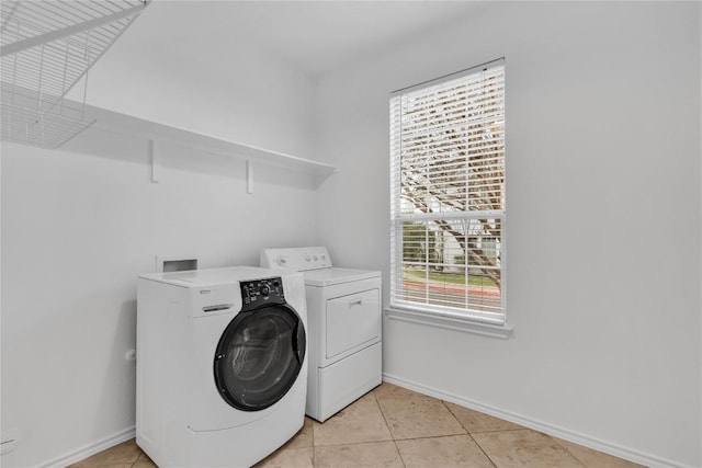 laundry area featuring light tile patterned floors and washer and dryer