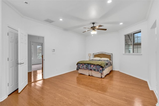 bedroom with crown molding, ceiling fan, and light wood-type flooring