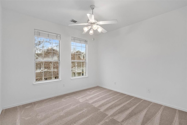 spare room with light carpet and ceiling fan