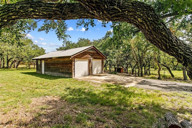 garage featuring a lawn