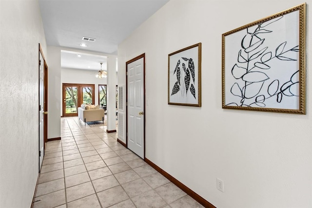 corridor with light tile patterned flooring