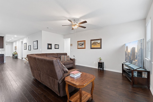 living room with ceiling fan and dark hardwood / wood-style flooring