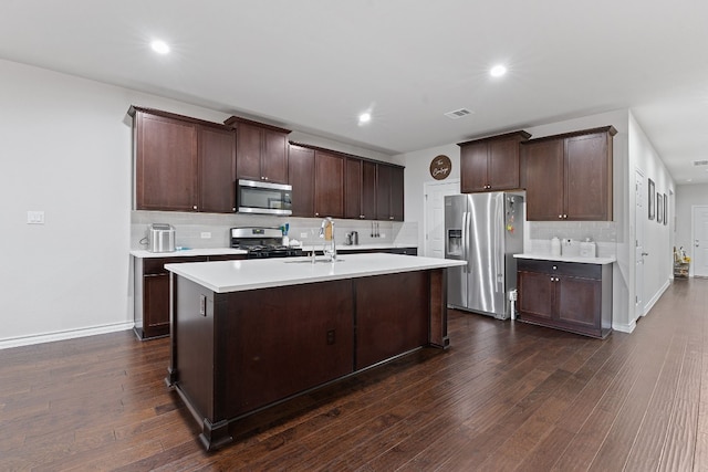 7716 Arezzo Dr, Round Rock, TX 78665 - kitchen with appliances with stainless steel finishes, decorative backsplash, light countertops, dark wood-style flooring, and recessed lighting