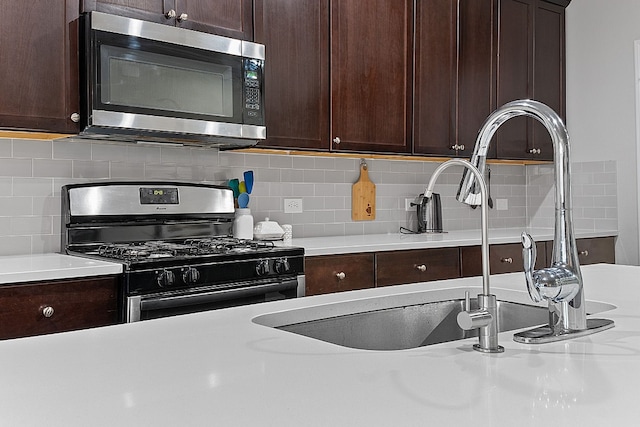 7716 Arezzo Dr, Round Rock, TX 78665 - kitchen featuring range with gas cooktop, stainless steel microwave, light countertops, and dark brown cabinetry