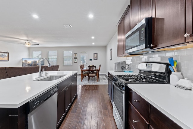 7716 Arezzo Dr, Round Rock, TX 78665 - kitchen with stainless steel appliances, light countertops, dark wood-style floors, recessed lighting, and tasteful backsplash