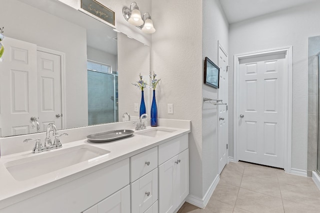 7716 Arezzo Dr, Round Rock, TX 78665 - full bath with double vanity, tiled shower, tile patterned flooring, and a textured wall