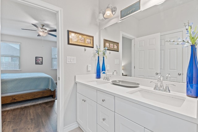 7716 Arezzo Dr, Round Rock, TX 78665 - ensuite bathroom featuring double vanity, a ceiling fan, and wood finished floors