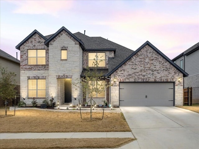 312 Olinda Way, Liberty Hill, TX 78642 - french country style house with stone siding, concrete driveway, fence, an attached garage, and a shingled roof