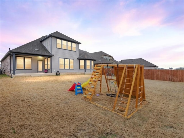 312 Olinda Way, Liberty Hill, TX 78642 - playground at dusk featuring fence and a playground