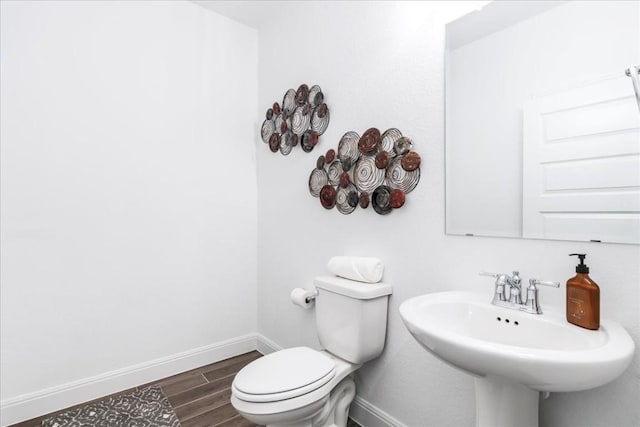 312 Olinda Way, Liberty Hill, TX 78642 - bathroom featuring baseboards, wood tiled floor, toilet, and a sink