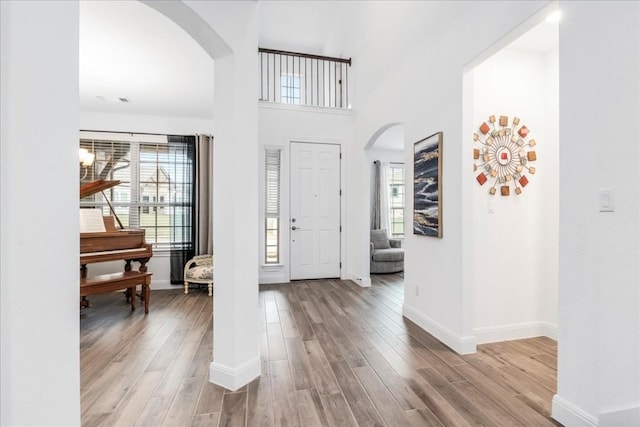 312 Olinda Way, Liberty Hill, TX 78642 - foyer entrance with arched walkways, baseboards, and wood finished floors