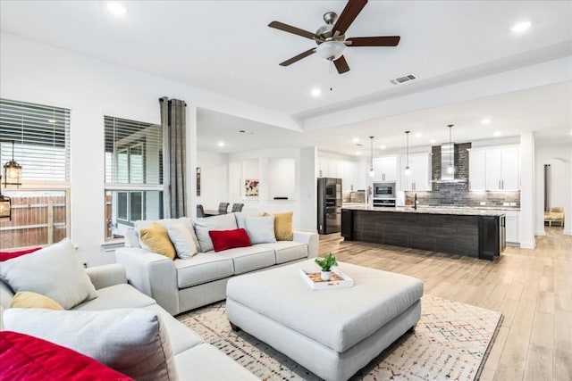 312 Olinda Way, Liberty Hill, TX 78642 - living area featuring light wood-type flooring, visible vents, recessed lighting, and a ceiling fan