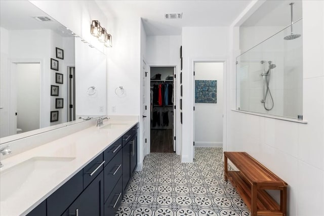 312 Olinda Way, Liberty Hill, TX 78642 - full bathroom featuring a sink, walk in shower, and visible vents