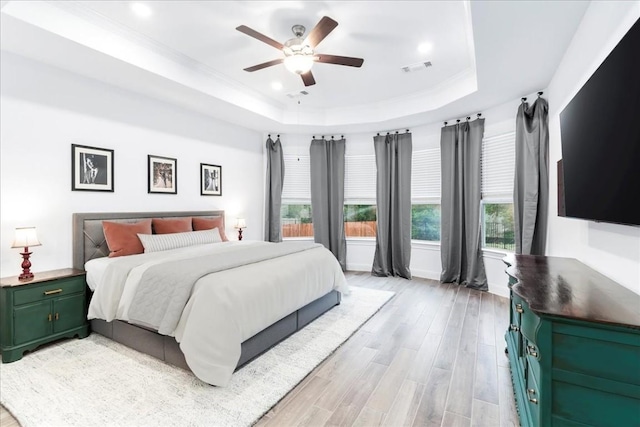 312 Olinda Way, Liberty Hill, TX 78642 - bedroom featuring a raised ceiling, ornamental molding, light wood finished floors, and visible vents