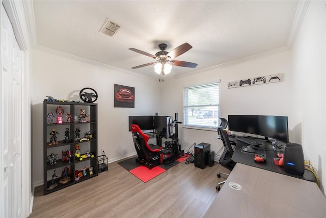 home office with crown molding, light hardwood / wood-style flooring, and ceiling fan