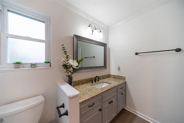 bathroom featuring vanity, crown molding, toilet, and hardwood / wood-style flooring